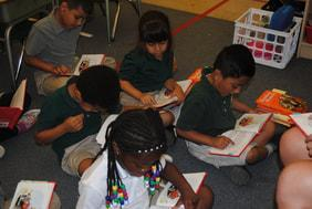 Students reading books together on the classroom carpet