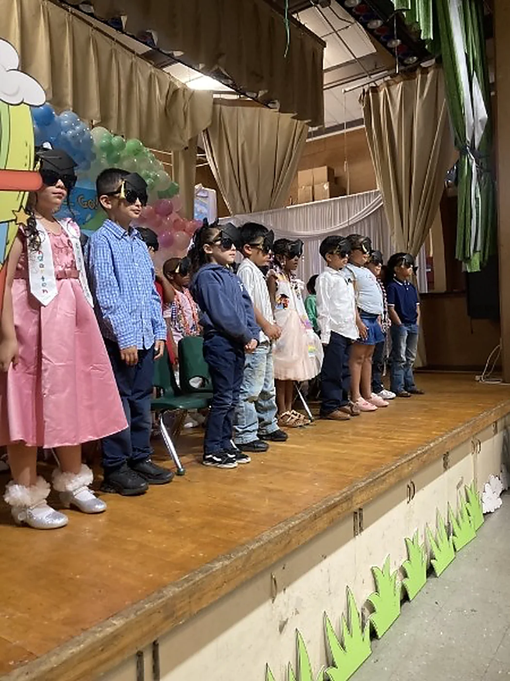 Families celebrating students on stage at the TK promotion ceremony
