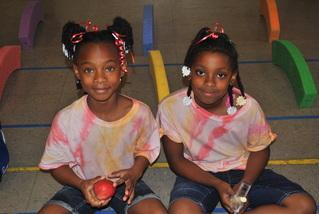 Two students sitting together in the gymnasium