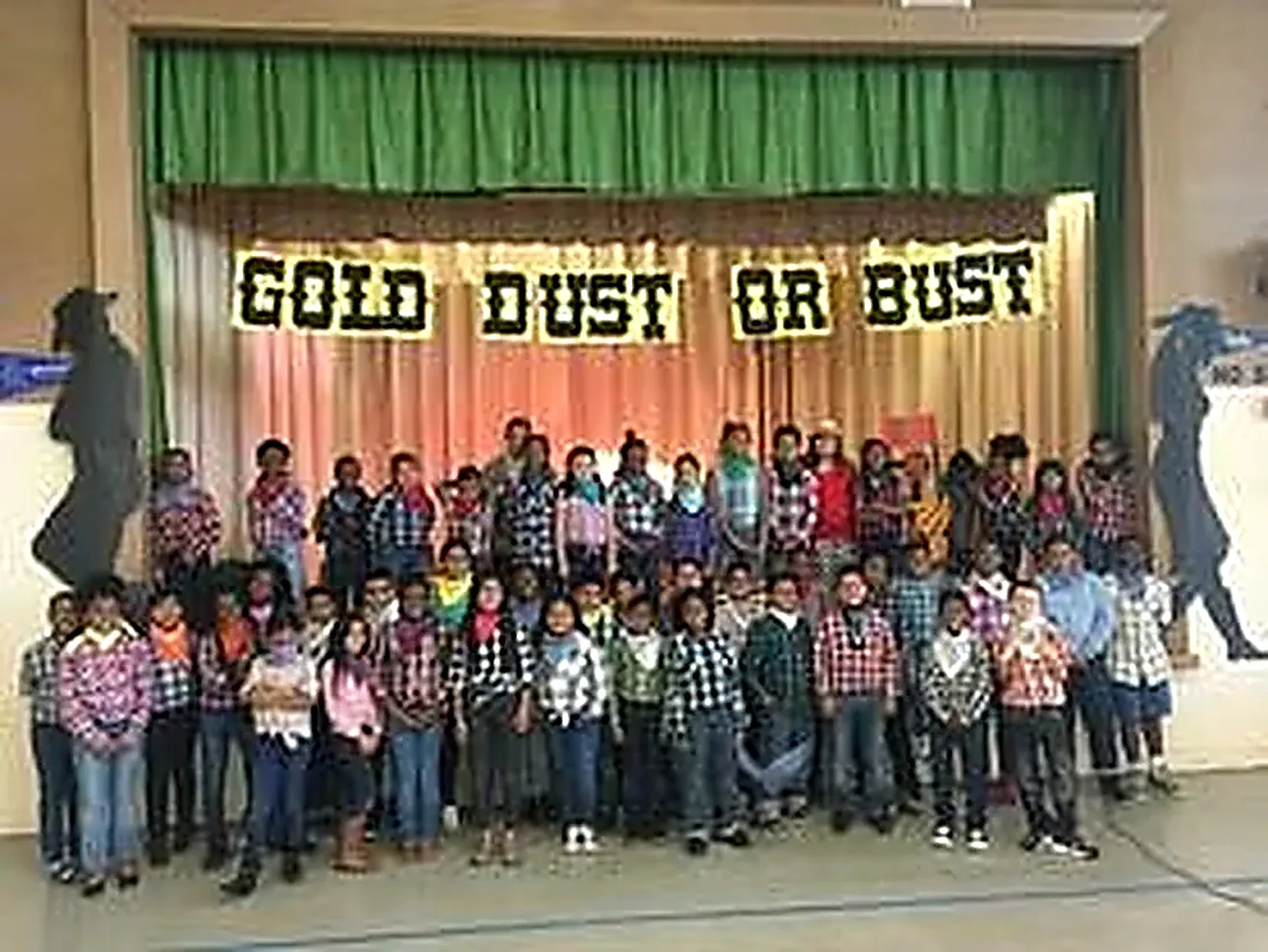 Students performing on stage during a school assembly