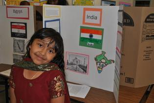 A student presenting her India project display board