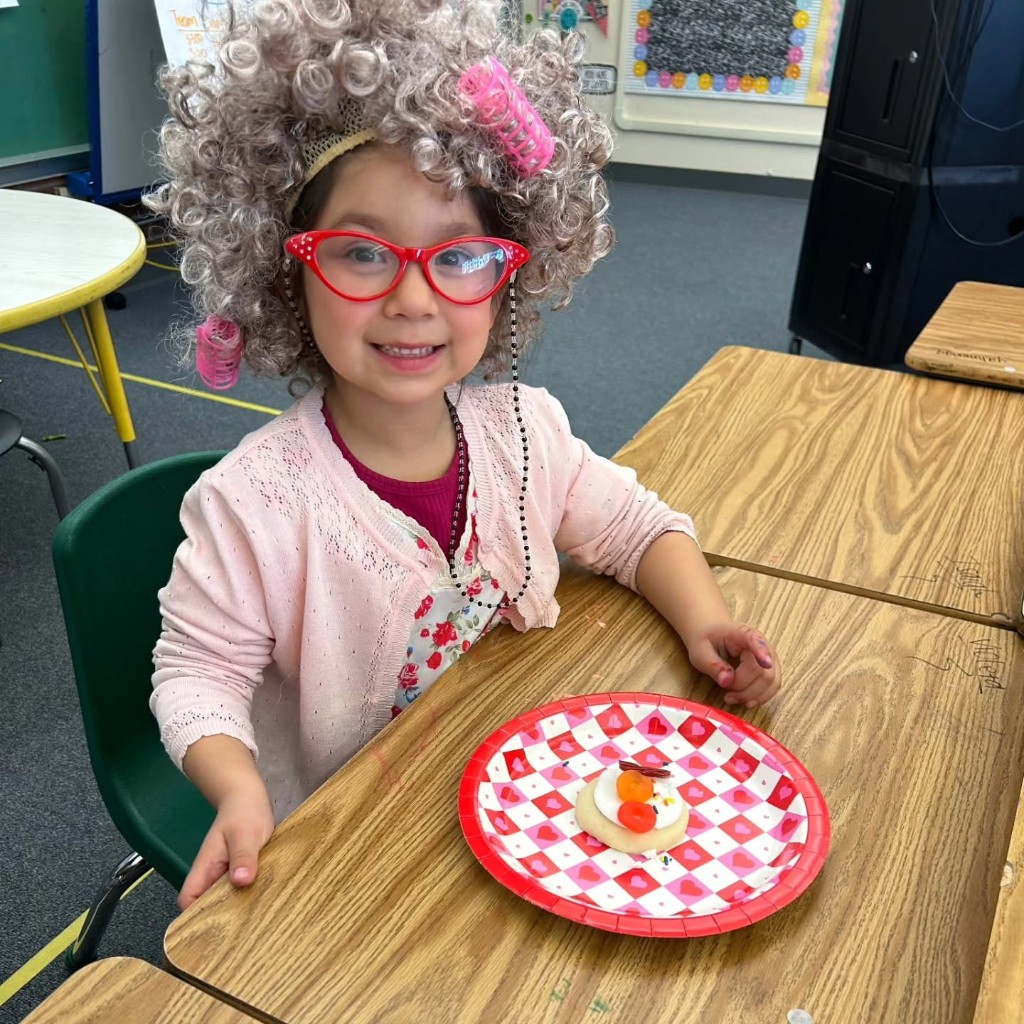 A student dressed up for a school celebration at her desk